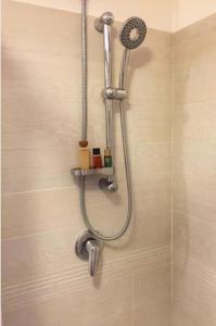 a shower with a shower head in a bathroom at Aurelia House in Rome