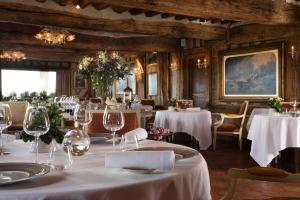 a dining room with tables with white tablecloths at La Ferme Saint Simeon Spa - Relais & Chateaux in Honfleur