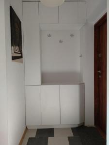 a white cabinet in a room with a wall at Sopot 35 in Sopot