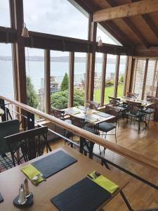 a restaurant with tables and chairs and a view of the ocean at Ferry House Inn in Milford Haven