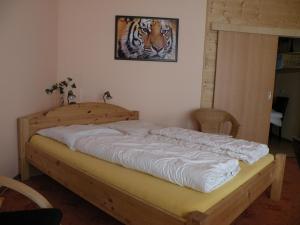 a bedroom with a wooden bed with at Apartments Schramm in Eisenach