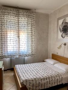 a bedroom with a bed and a window at Castelfranco Hotel in Castelfranco Emilia