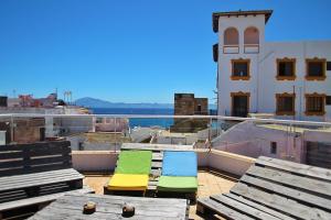 two lounge chairs on the roof of a building at SurfersResidence Apartments in Tarifa