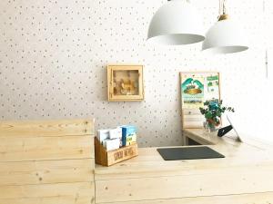 a shop with a wooden counter and two pendant lights at Hostal Beni in Benicàssim