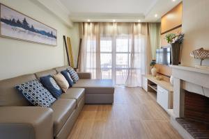 a living room with a couch and a fireplace at Ericeira Sunset Lifestyle II in Ericeira