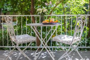 a table and two chairs with a bowl of fruit at Luxury rooms with balcony in Zadar