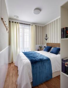 a bedroom with a large bed with blue pillows at "Breeze" Aparthotel by Parrot`s House in Lloret de Mar