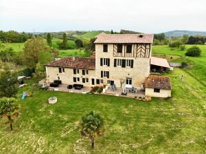 an aerial view of a large house in a field at A CLAIREFONTAINE in Auch