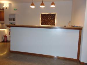 a large white counter in a room with lights at Polyxeni Hotel in Pythagoreio