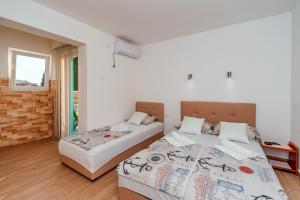 Postel nebo postele na pokoji v ubytování Apartmani Afterglow