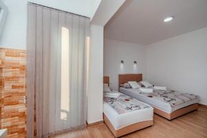 Postel nebo postele na pokoji v ubytování Apartmani Afterglow