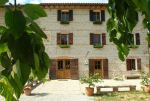 a large stone building with doors and windows at Le Fade in Susegana