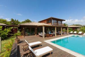 a villa with a swimming pool and a house at Casa 10 -Txai Resort in Itacaré