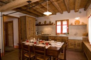 a kitchen with a wooden table and a dining room at Le Fade in Susegana +18 photos