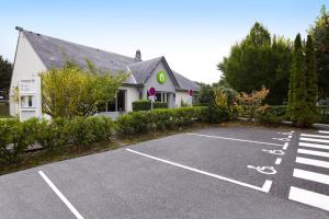 a parking lot in front of a house at Campanile Le Havre Nord - Montivilliers in Montivilliers
