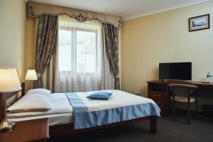 Postel nebo postele na pokoji v ubytování Hotel Patriarshyi