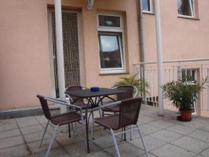 a table and chairs sitting on a patio at Pension Domicil in Leipzig