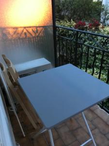 a table and a chair on a balcony at Studio in the center of Saint-Jean-cap-Ferrat in Saint-Jean-Cap-Ferrat