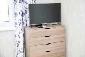 a television on top of a dresser in a room at New House Comfort Apartment in Odesa