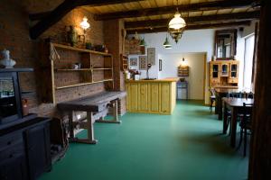 a room with a green floor and a dining room at Satul Banului Guesthouse in Măgureni