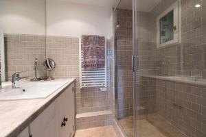 a bathroom with a glass shower and a sink at Le Pigeonnier in Saint-Tropez +17 photos