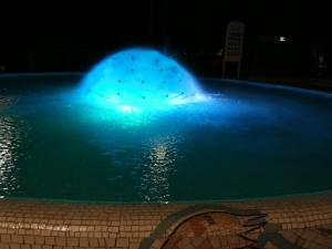 una luce blu in una piscina di notte di Hotel Tivoli a Misano Adriatico