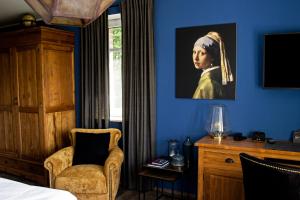 a room with a bedroom with a painting of a woman at Boutique Hotel Kauers in Verl