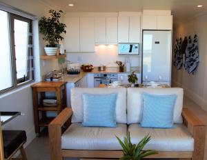 a living room with a couch in a kitchen at Oceans Guest House & Luxurious Apartments in Struisbaai