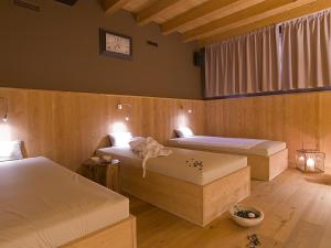 En eller flere senger på et rom på AR Mountains Lodge Villachiara