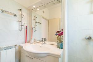 a white bathroom with a sink and a shower at Apartment Complex Kampic in Poreč +50 photos