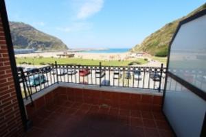 a balcony with a view of a beach and the ocean at Balea 3 - Local Rentss in Orio