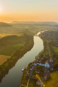 an aerial view of a river with a house in the middle at Gasthof Hirschen in Gailingen