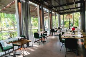 a restaurant with tables and chairs and large windows at Boutique Hotel Borgo Nuovo in Milan