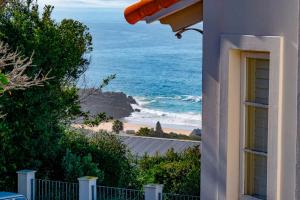 a building with a view of the ocean and a beach at Lavender hill in Plettenberg Bay