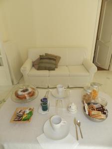 sala de estar con sofá y mesa con comida en Palazzo Morese Apartments, en Salerno