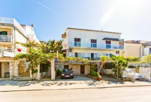 a house with a car parked in front of it at Rooms Barbarić in Hvar