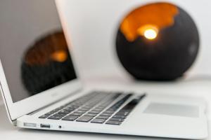 a laptop computer sitting on top of a table at Mykonian Mews Luxury Suites in Psarou