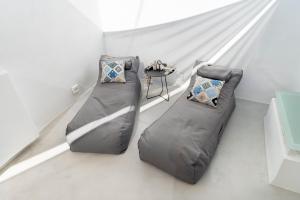 two bean bags in a room with a bed at Mykonian Mews Luxury Suites in Psarou