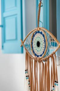 a wicker basket with a blue and white at Mykonian Mews Luxury Suites in Psarou