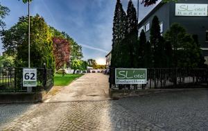 a street with a fence and a sign on it at SL'otel Budget in Bernburg