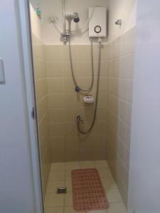 a bathroom with a shower with a red rug at HappyNest 1857 @ Cityland Tagaytay in Tagaytay