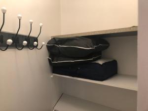 a closet with two bags on a shelf at Résidence Le Club in Saint-Jean-de-Monts
