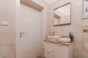 a bathroom with a sink and a mirror at Casa Mia apartment in Vodnjan +7 photos
