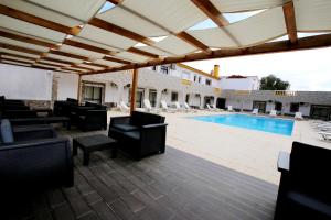a patio with chairs and a swimming pool at Belo Horizonte in Luz