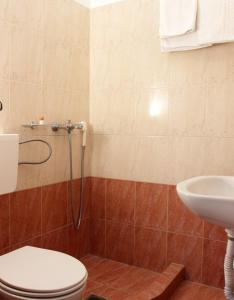 a bathroom with a toilet and a sink at Noni Rooms in Agia Triada