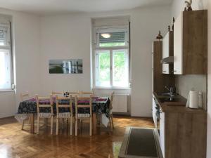 a kitchen with a table and chairs in a room at Lilians modern Appartement in historical Citycenter in Graz