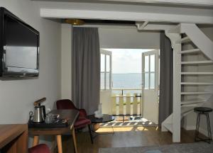 a living room with a view of the ocean at Hotel Spaander BW Signature Collection in Volendam