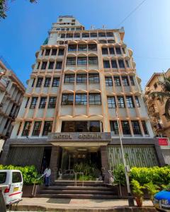 a large building with stairs in front of it at Hotel Godwin - Colaba in Mumbai