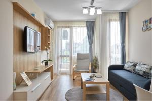 a living room with a couch and a table at RELAX CENTER Burgas & Free PARKING in Burgas City