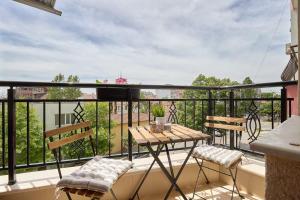 a balcony with a table and chairs on a balcony at RELAX CENTER Burgas & Free PARKING in Burgas